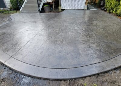 Custom stamped concrete patio installation, offering a sleek and modern outdoor upgrade.