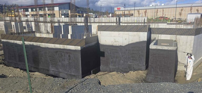 Row of commercial foundation walls with black waterproofing membrane