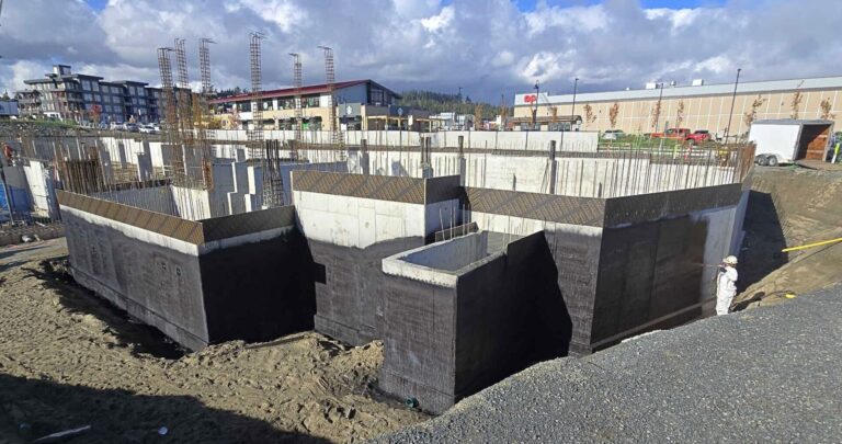 Commercial foundation walls coated in black waterproofing membrane