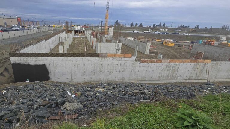 Long run of waterproofed foundation walls along a commercial excavation