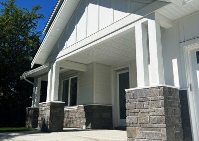 Stone veneer column wraps installed on the front entrance of a modern residential home in Victoria, BC.