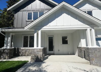 Stone veneer column wraps installed on the front entrance of a modern residential home in Victoria, BC.