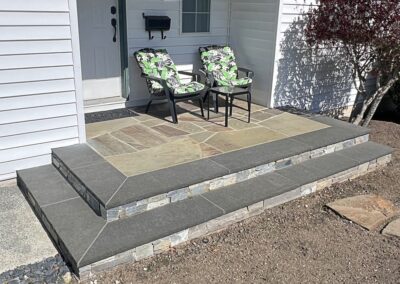 Custom natural stone porch with multi-tone flagstone and stacked stone steps in Victoria, BC.