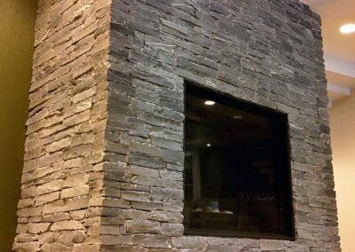 Stone fireplace installation at Fairways Hotel by Orca Masonry using natural K2 Stone veneer.