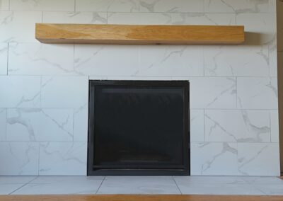 Modern fireplace installation with Carrara porcelain tile by Orca Masonry in Victoria BC