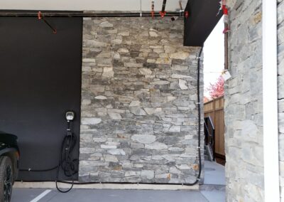 Exterior view of natural stone veneer installation using Ocean Mist stone from K2 Stone at a mixed-use development on 713 St. Patrick Street in Oak Bay