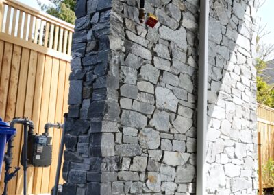 Exterior view of natural stone veneer installation using Ocean Mist stone from K2 Stone at a mixed-use development on 713 St. Patrick Street in Oak Bay