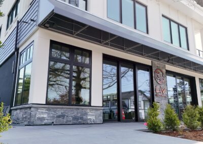 Exterior view of natural stone veneer installation using Ocean Mist stone from K2 Stone at a mixed-use development on 713 St. Patrick Street in Oak Bay