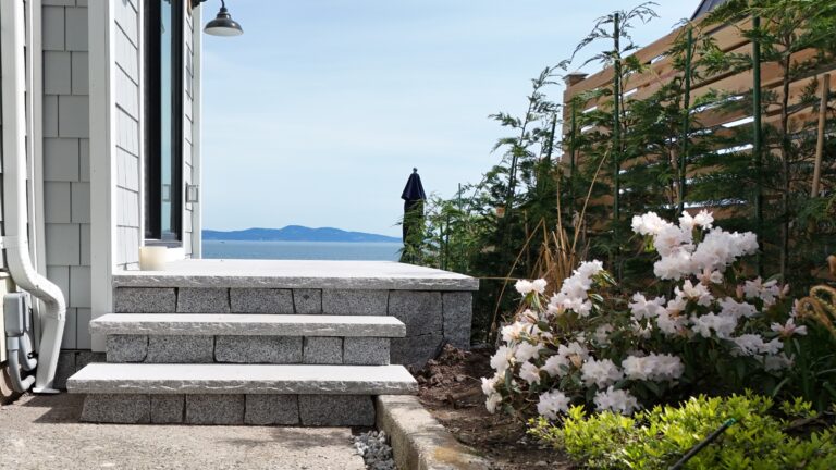 Granite block steps and landing with the ocean beyond