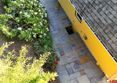 Bluestone patio installation around a residential home in Greater Victoria BC completed by Orca Masonry