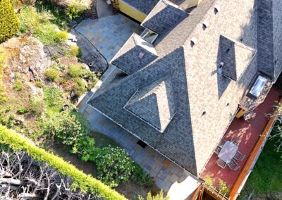 Bluestone patio installation around a residential home in Greater Victoria BC completed by Orca Masonry