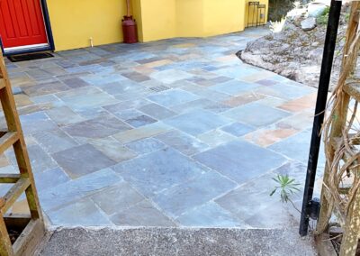 Bluestone patio installation around a residential home in Greater Victoria BC completed by Orca Masonry