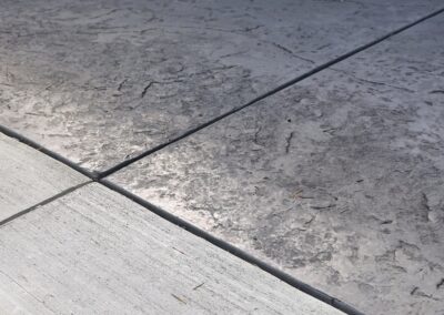 Stamped concrete patio finished with an Oxford Slate pattern. Durable, low-maintenance, and ideal for outdoor living spaces across Victoria and Vancouver Island.