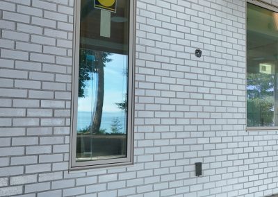 Exterior white brick façade on modern custom home in Victoria by Orca Masonry