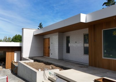 Exterior white brick façade on modern custom home in Victoria by Orca Masonry