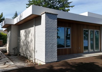 Exterior white brick façade on modern custom home in Victoria by Orca Masonry