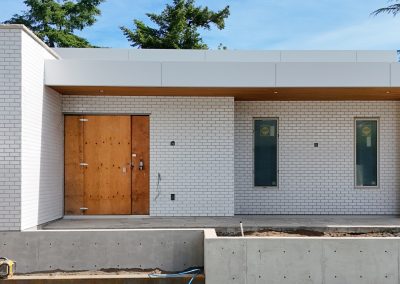 Exterior white brick façade on modern custom home in Victoria by Orca Masonry