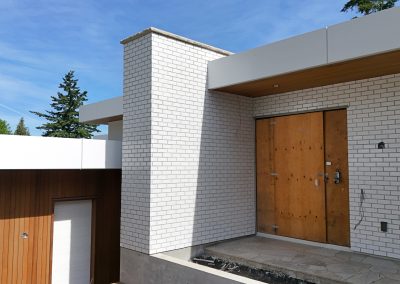 Exterior white brick façade on modern custom home in Victoria by Orca Masonry