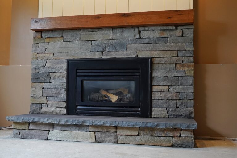 Natural stone veneer fireplace surround with a basalt hearth