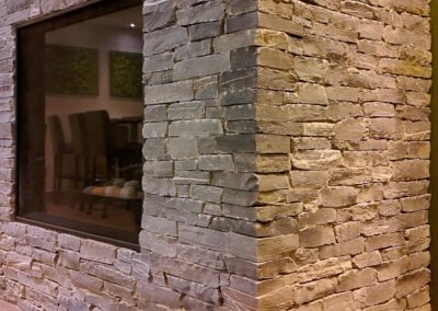 Stone fireplace installation at Fairways Hotel by Orca Masonry using natural K2 Stone veneer.