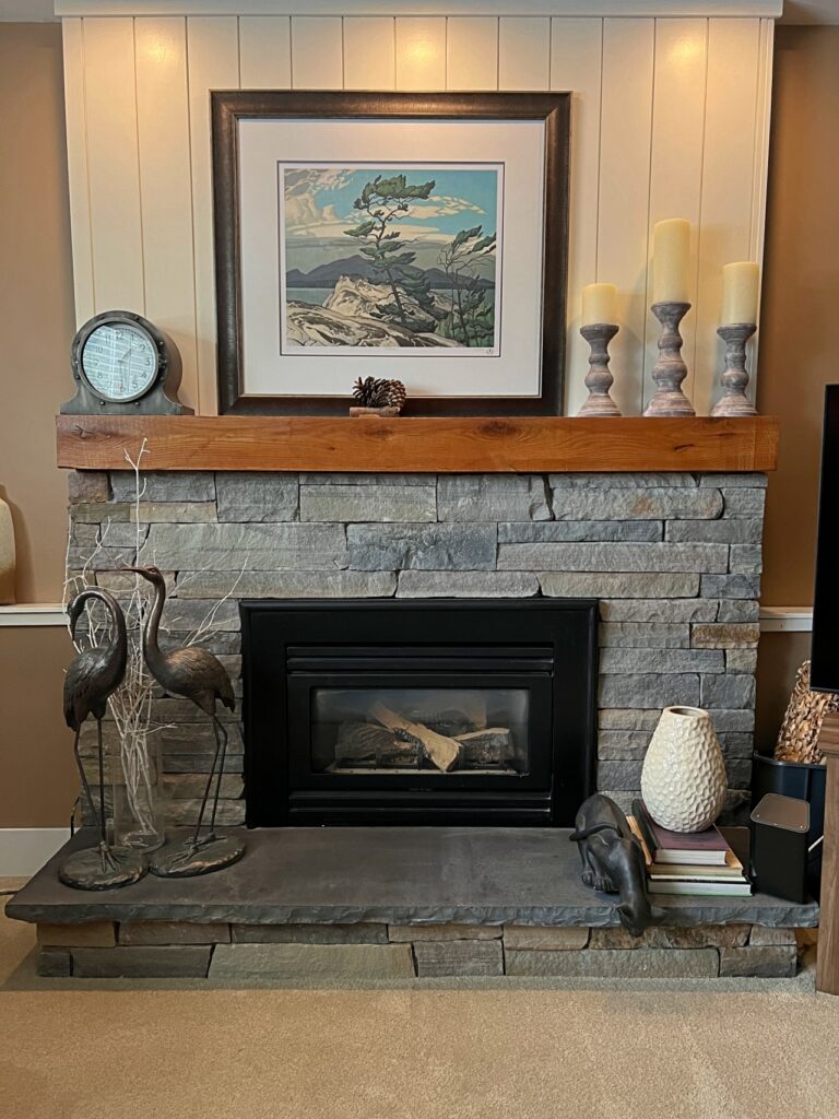 Rustic stone fireplace with a natural wood mantel