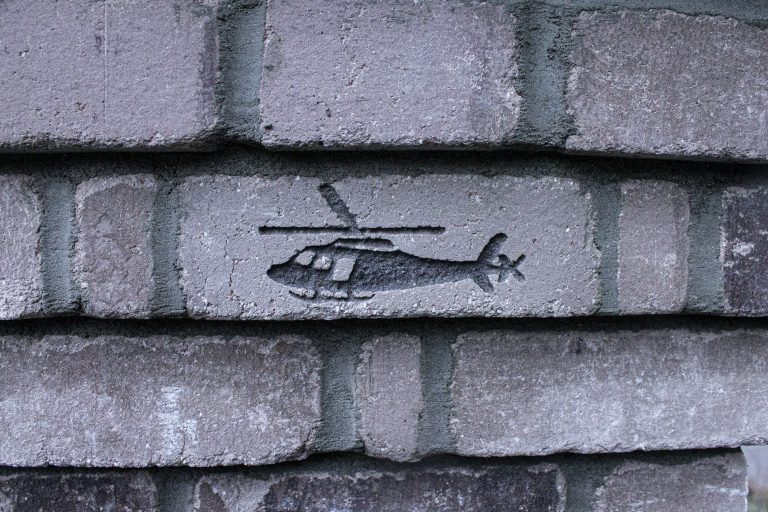 Close-up of a helicopter engraved into a chimney brick