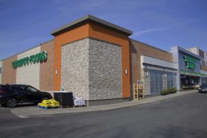 Commercial building exterior with manufactured stone veneer, brick, and modern architectural paneling.