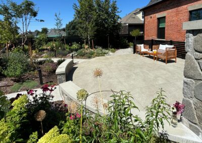 Rustic stone bench and wall installation by Orca Masonry in a landscaped outdoor space in Victoria, BC