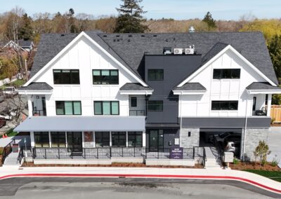 Exterior view of natural stone veneer installation using Ocean Mist stone from K2 Stone at a mixed-use development on 713 St. Patrick Street in Oak Bay