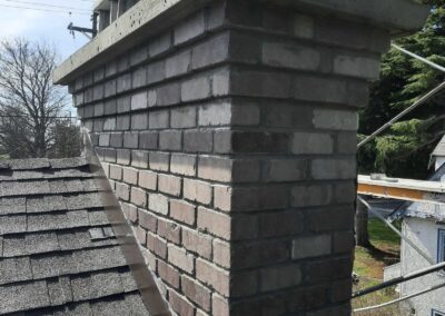 Light Grey Flashed Brick With Multi-Step Corbel and Concrete Crown