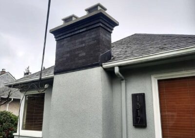 Dark Flashed Brick With Multi-Step Corbel and Concrete Crown