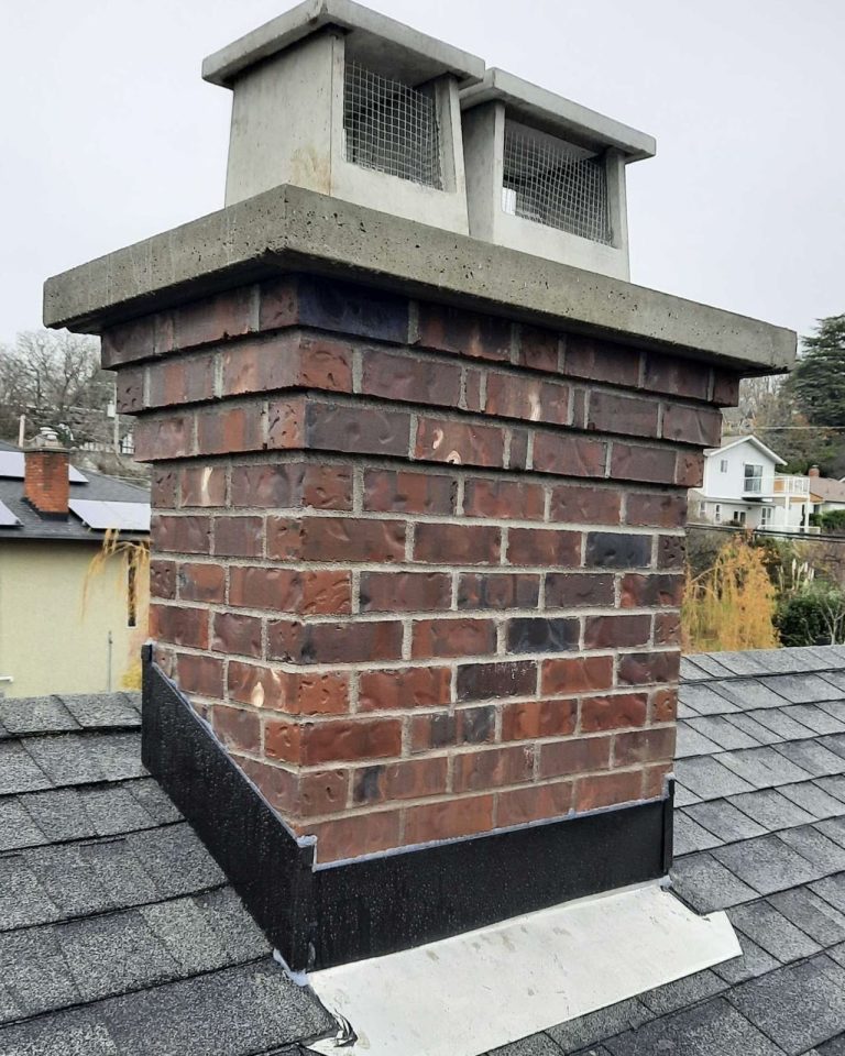 Covington brick chimney with corbelled courses, a concrete crown, twin caps and new flashing