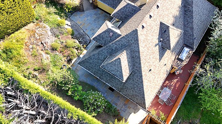 Aerial view of the house with flagstone paths and courtyard wrapping around it