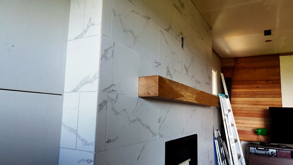 Video: a modern fireplace wall finished in large Carrara-look porcelain tile