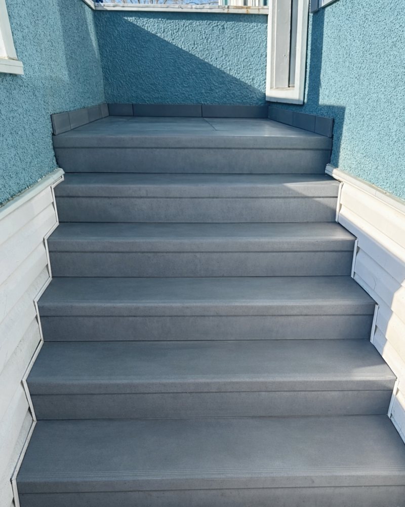 The same entry steps after StepClad, with clean grey treads and risers