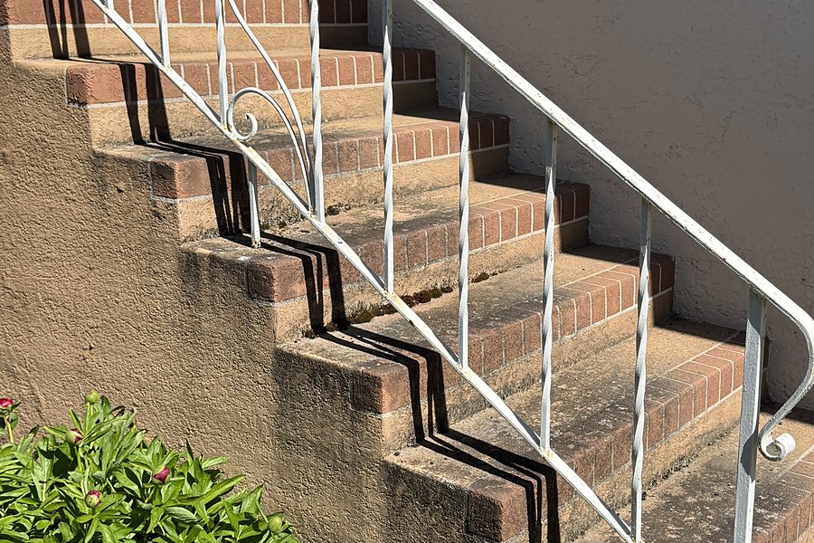 Painted brick steps with faded, peeling paint