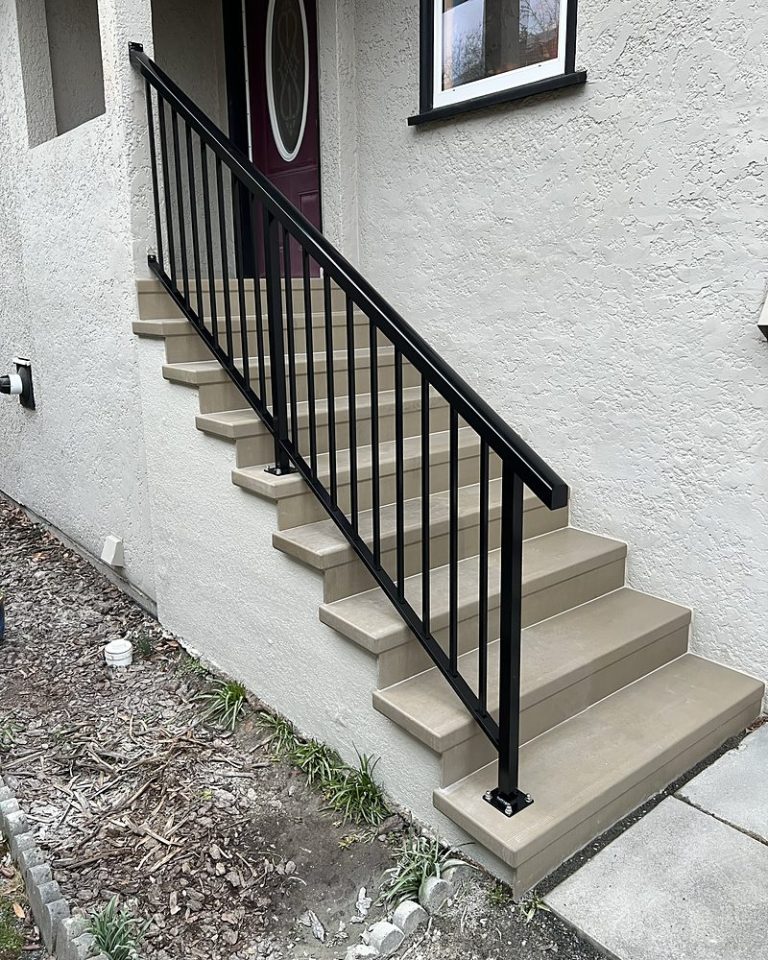 Entry steps finished in StepClad beside a metal railing