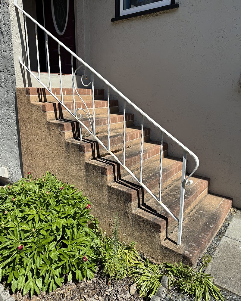 Old painted brick entry steps, faded and peeling, before StepClad