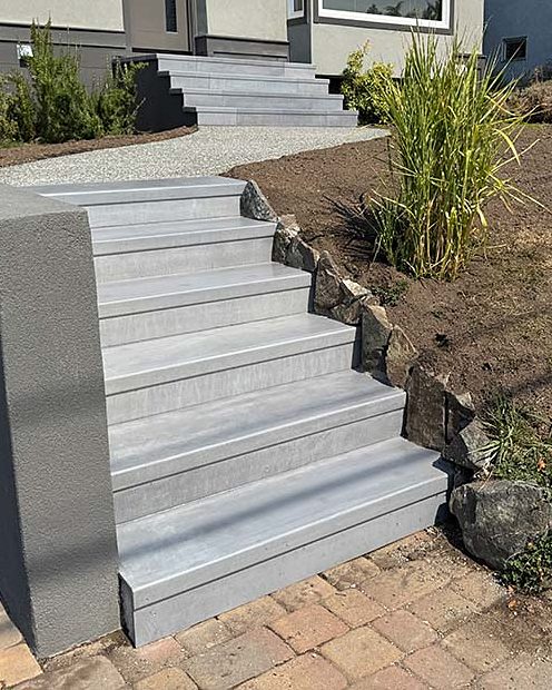 The same front walk steps after StepClad, light grey and even